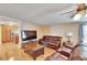 Living area with hardwood floors and a large TV at 3022 Short Leaf St, Wesley Chapel, FL 33543