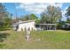 Ranch style home with carport and large grassy yard at 309 4Th Sw Ave, Ruskin, FL 33570