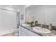 Double vanity bathroom with granite countertop and tiled shower at 32611 Turtle Grace Loop, Wesley Chapel, FL 33545