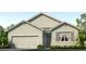 Single-story house with light-grey siding, shutters, and a two-car garage at 32722 Osprey Peak Way, San Antonio, FL 33576