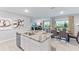 Open concept kitchen with large island and granite countertop at 32722 Osprey Peak Way, San Antonio, FL 33576