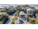 Aerial view of waterfront home with surrounding neighborhood and palm trees at 3478 Gum Dr, Weeki Wachee, FL 34607