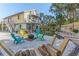 Fire pit area with colorful chairs and a hammock in the backyard at 3478 Gum Dr, Weeki Wachee, FL 34607