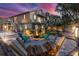 Evening view of backyard with fire pit, seating, and hammock at 3478 Gum Dr, Weeki Wachee, FL 34607