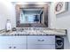 Modern bathroom vanity with granite countertop and rustic mirror at 3478 Gum Dr, Weeki Wachee, FL 34607