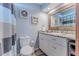 Updated bathroom with granite countertop and a large mirror at 3478 Gum Dr, Weeki Wachee, FL 34607