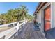 Wooden deck with seating area and view of tropical landscape at 3478 Gum Dr, Weeki Wachee, FL 34607