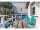 Charming deck with teal chairs and potted plants at 3478 Gum Dr, Weeki Wachee, FL 34607