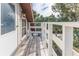 Elevated deck with white railing and view of trees at 3478 Gum Dr, Weeki Wachee, FL 34607