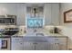 Bright kitchen features stainless steel appliances and granite countertops at 3478 Gum Dr, Weeki Wachee, FL 34607