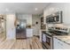 Modern kitchen with stainless steel appliances and light wood flooring at 3478 Gum Dr, Weeki Wachee, FL 34607