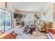 Cozy living room with a large TV, cowhide rug, and comfy sofa at 3478 Gum Dr, Weeki Wachee, FL 34607