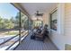 Cozy screened porch with wicker furniture, perfect for relaxing at 3478 Gum Dr, Weeki Wachee, FL 34607