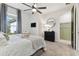 Bright bedroom featuring a king-size bed, a ceiling fan, and an ensuite bathroom at 4316 Cairoli Ct, Wesley Chapel, FL 33543