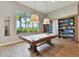 Relaxing game room with a pool table and built-in shelving at 4316 Cairoli Ct, Wesley Chapel, FL 33543