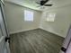 Spacious bedroom with wood-look flooring and two windows at 4605 Irene Loop, New Port Richey, FL 34652