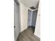 Hallway with grey doors and wood-look flooring at 4605 Irene Loop, New Port Richey, FL 34652