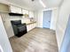 Modern kitchen with white cabinets, black appliances, and a light gray floor at 4605 Irene Loop, New Port Richey, FL 34652