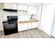 Newly remodeled kitchen, white cabinets, black appliances, and white subway tile at 4605 Irene Loop, New Port Richey, FL 34652