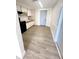 Modern kitchen with white cabinets, black appliances, and a light gray floor at 4605 Irene Loop, New Port Richey, FL 34652