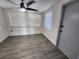 Bright living room with gray vinyl flooring and neutral walls at 4605 Irene Loop, New Port Richey, FL 34652