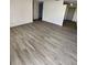 Spacious living area showcasing light gray vinyl plank flooring at 4605 Irene Loop, New Port Richey, FL 34652