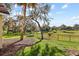 Backyard with palm tree and a view of the golf course at 4909 Sylvan Oaks Dr, Valrico, FL 33596