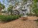 Large backyard with gravel ground cover, lush greenery and a patio set at 514 Wideview Ave, Tarpon Springs, FL 34689