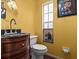 Small bathroom with dark wood vanity and yellow walls at 514 Wideview Ave, Tarpon Springs, FL 34689