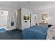 Spacious bedroom with a large bed, TV, and access to bathroom at 514 Wideview Ave, Tarpon Springs, FL 34689