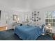 Bedroom with blue bedding, wicker furniture, and decorative plates at 514 Wideview Ave, Tarpon Springs, FL 34689