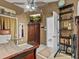 Bedroom with wooden sleigh bed, ceiling fan, and built-in shelving at 514 Wideview Ave, Tarpon Springs, FL 34689