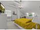 Bright bedroom with a mustard yellow comforter and white furniture at 514 Wideview Ave, Tarpon Springs, FL 34689