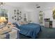 Comfortable bedroom with blue sofa bed, decorative plates, and window at 514 Wideview Ave, Tarpon Springs, FL 34689