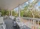 Relaxing deck with wooden flooring, white railings, and comfortable seating at 514 Wideview Ave, Tarpon Springs, FL 34689
