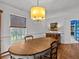 Charming dining room with an oval table, chandelier, and hardwood floors at 514 Wideview Ave, Tarpon Springs, FL 34689