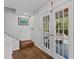 Bright entryway with hardwood floors, French doors, and staircase at 514 Wideview Ave, Tarpon Springs, FL 34689