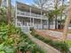 Two-story house with wrap-around porch, driveway, and landscaped yard at 514 Wideview Ave, Tarpon Springs, FL 34689