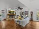Spacious living room with stone fireplace, hardwood floors, and plenty of natural light at 514 Wideview Ave, Tarpon Springs, FL 34689