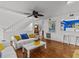 Open concept living room with hardwood floors, white sofa, and kitchen view at 514 Wideview Ave, Tarpon Springs, FL 34689
