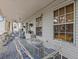 Screened porch with glass top table and wicker furniture at 514 Wideview Ave, Tarpon Springs, FL 34689