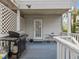 Deck features a grill, white railing, and exterior door access at 514 Wideview Ave, Tarpon Springs, FL 34689