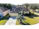Aerial view of charming yellow house and yard at 5215 New Brittany Ln, Zephyrhills, FL 33541