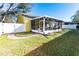 Backyard with screened porch and fire pit at 5215 New Brittany Ln, Zephyrhills, FL 33541