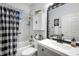 Clean bathroom with black and white shower curtain at 5215 New Brittany Ln, Zephyrhills, FL 33541