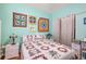Bedroom with light walls, floral bedding, and wall art at 5215 New Brittany Ln, Zephyrhills, FL 33541