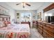 Main bedroom with a king-size bed and ample dresser space at 5215 New Brittany Ln, Zephyrhills, FL 33541