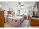 Spacious bedroom with wooden furniture and floral bedding at 5215 New Brittany Ln, Zephyrhills, FL 33541