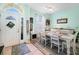 Bright dining room with white table and chairs, and decorative accents at 5215 New Brittany Ln, Zephyrhills, FL 33541