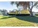Cute yellow house with nicely landscaped lawn at 5215 New Brittany Ln, Zephyrhills, FL 33541
